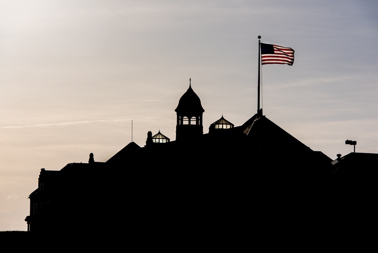 A building silhouette with a flag